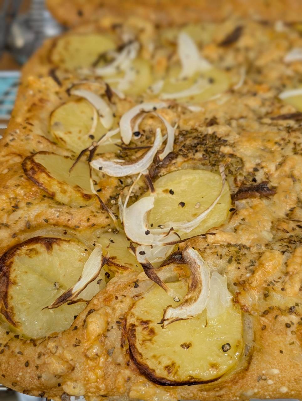 Potato and anchovy focaccia with roasted onion slices and rosemary, baked fresh daily at Focaccino Hakuba