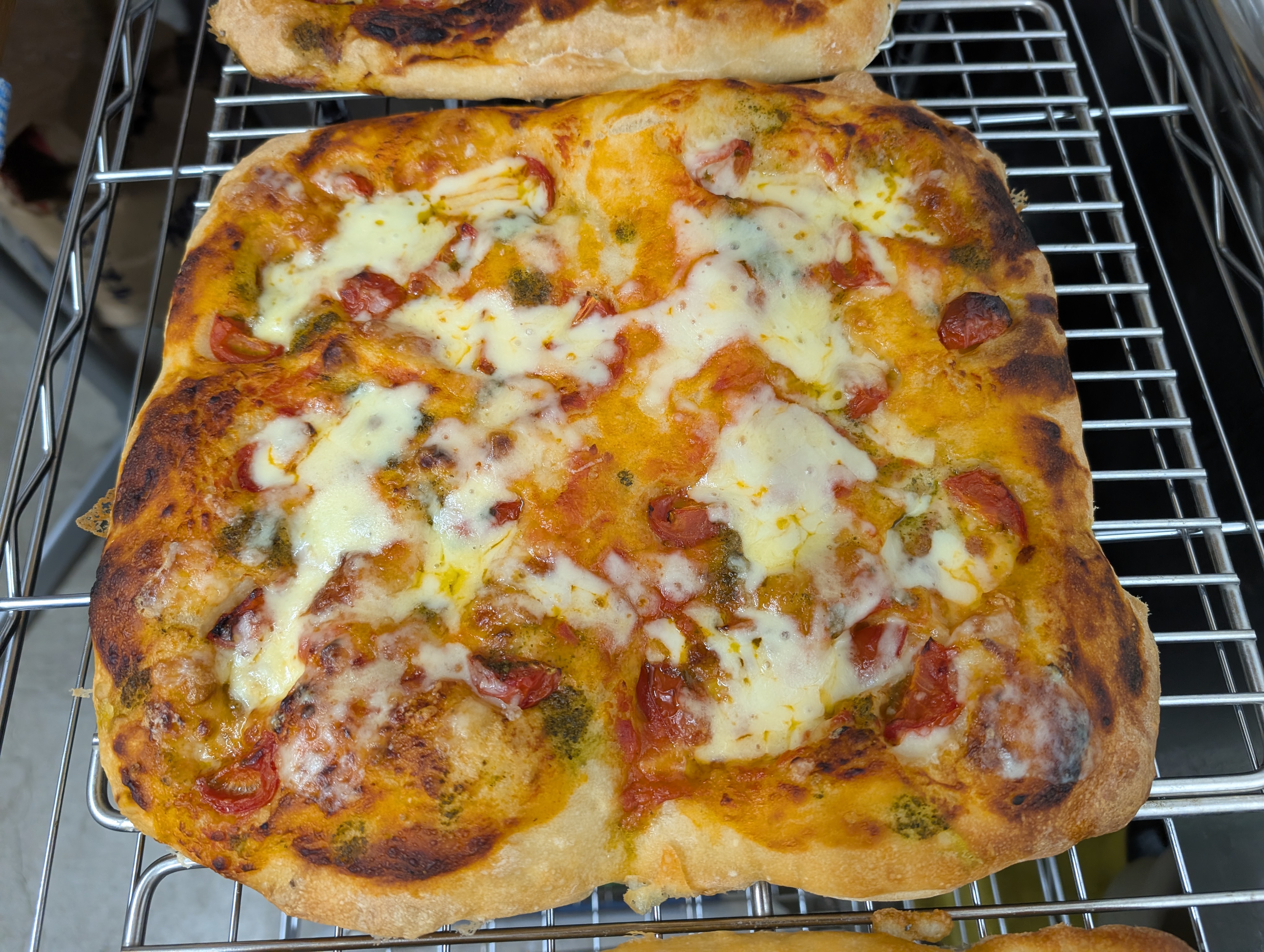 Freshly baked topping focaccia with melted cheese, tomatoes and herbs